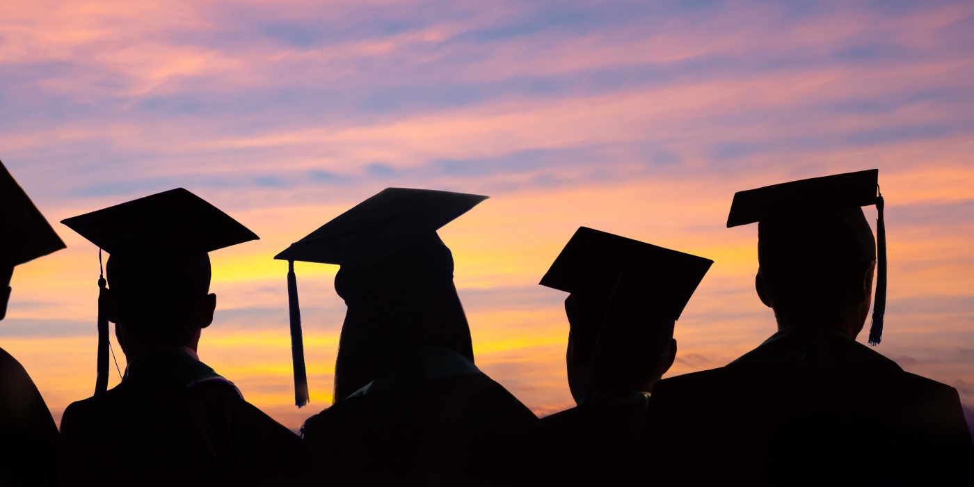 Graduates in front of sunset