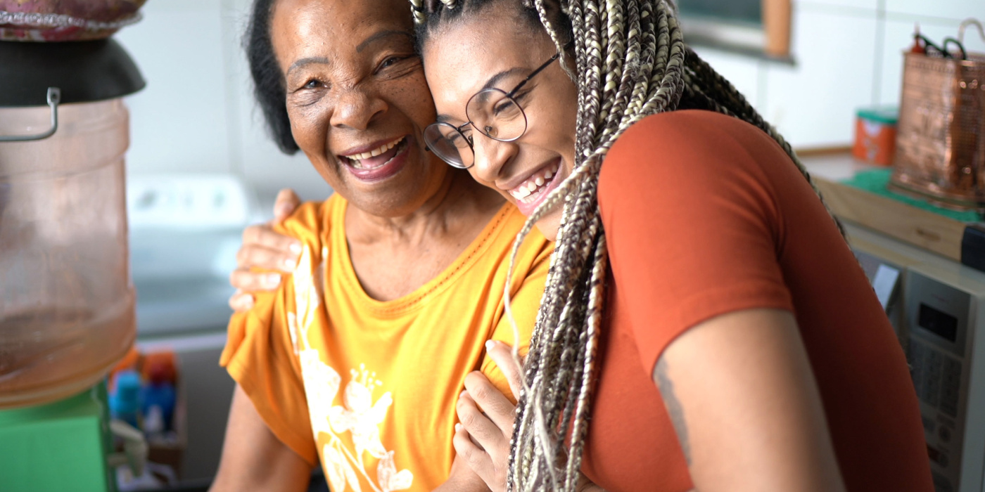 Smniling elderly African American woman and young woman