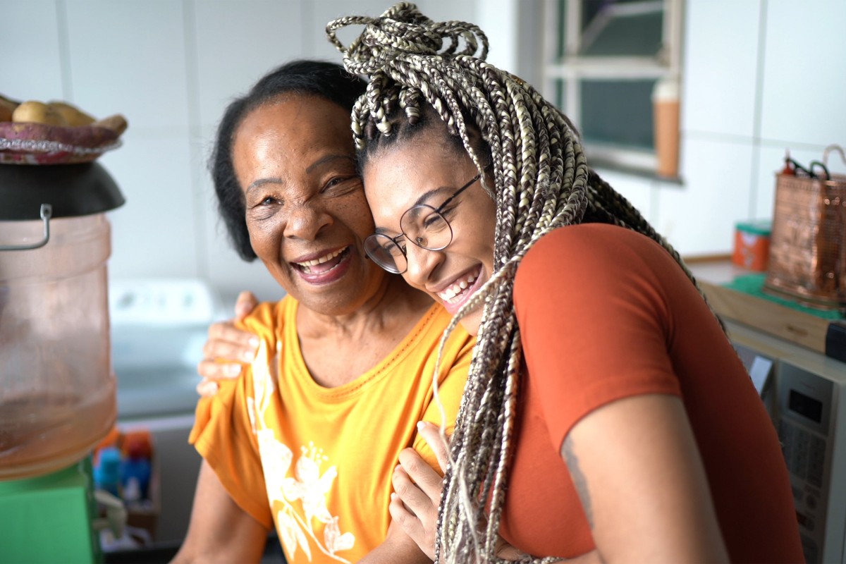 Smniling elderly African American woman and young woman